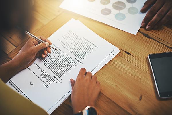 Two individuals completing paperwork